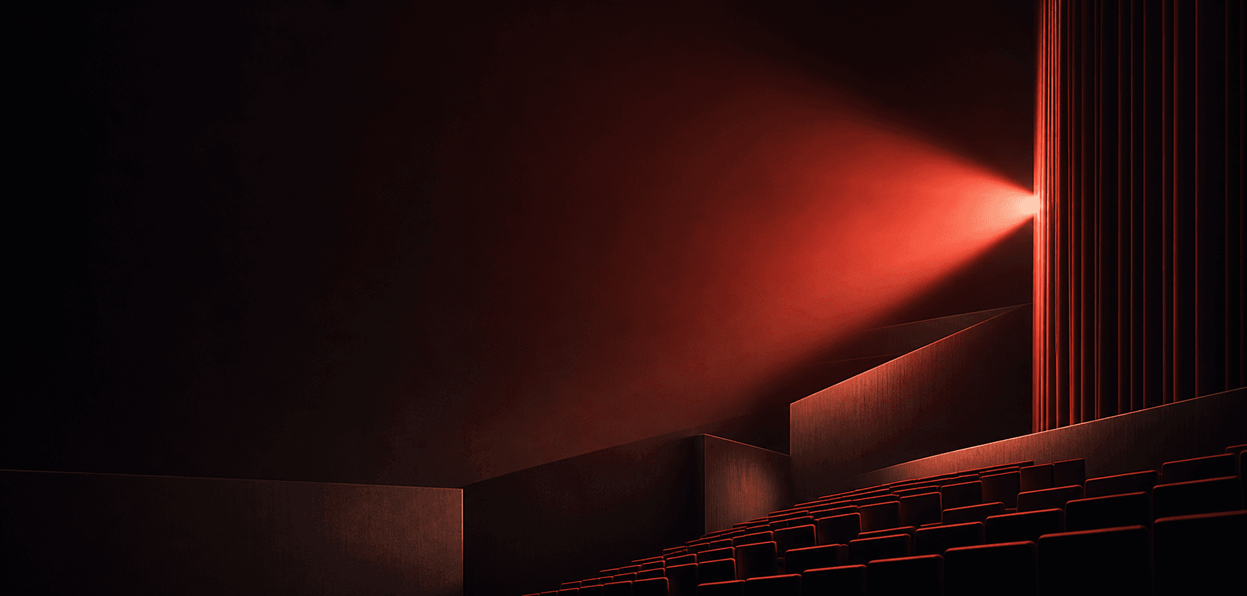 A red projection beam crossing a quiet modern cinema